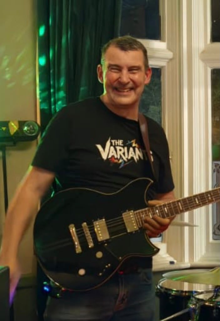 Steve smiling with his electric guitar